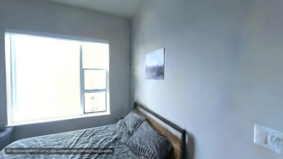 The bedroom: a bed under a wide window.