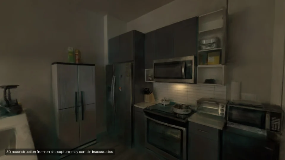 The kitchen: fridge, oven and wall cabinets.